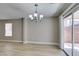 Dining area featuring modern lighting, wood-look floors, and backyard access at 11147 Verismo St, Las Vegas, NV 89141