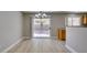 Dining area with wood-look flooring, chandelier, and sliding door to backyard, blending indoor/outdoor living at 11147 Verismo St, Las Vegas, NV 89141