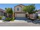 Two-story home with a two car garage and a well-manicured lawn at 11147 Verismo St, Las Vegas, NV 89141