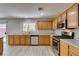 Spacious kitchen with stainless steel appliances, wood cabinets, and a backyard view at 11147 Verismo St, Las Vegas, NV 89141