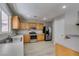 Modern kitchen featuring wood cabinets, stainless steel appliances, and wood-look floors at 11147 Verismo St, Las Vegas, NV 89141