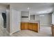 Open-concept kitchen area offers wood cabinets, and easy access to stairs and dining at 11147 Verismo St, Las Vegas, NV 89141