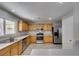Charming kitchen features stainless steel appliances, natural wood cabinetry, and updated countertops at 11147 Verismo St, Las Vegas, NV 89141
