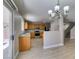 Open kitchen with backyard access, wood cabinets, stainless steel appliances, and wood-look floors at 11147 Verismo St, Las Vegas, NV 89141