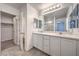 Well-lit bathroom featuring double sinks, modern cabinets, and tile flooring for a clean aesthetic at 1197 Mission View Ct, Henderson, NV 89002