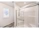 Clean bathroom with a glass-enclosed shower, modern fixtures, and a bright window for natural light at 1197 Mission View Ct, Henderson, NV 89002
