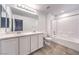 Bright bathroom features a double sink vanity, a large mirror, and a shower over tub at 1197 Mission View Ct, Henderson, NV 89002