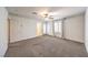 Spacious bedroom featuring carpet, a ceiling fan, and a doorway leading to an outdoor patio or balcony at 1197 Mission View Ct, Henderson, NV 89002