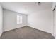 Neutrally decorated bedroom featuring carpet, natural light from shuttered window, and ample space at 1197 Mission View Ct, Henderson, NV 89002