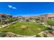 Aerial view of a neighborhood park with lush green space and a playground for outdoor enjoyment at 1197 Mission View Ct, Henderson, NV 89002