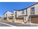 Charming townhouse exteriors featuring garages, well-maintained landscaping, and stucco siding for a modern look at 1197 Mission View Ct, Henderson, NV 89002