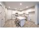 Bright kitchen boasts white cabinets, stainless steel appliances, and a spacious center island with bar seating at 1197 Mission View Ct, Henderson, NV 89002