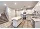 Bright kitchen with white cabinets, stainless appliances, a kitchen island, and tile flooring at 1197 Mission View Ct, Henderson, NV 89002