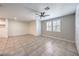 Spacious living area featuring tile floors, a ceiling fan, and lots of natural light at 1197 Mission View Ct, Henderson, NV 89002