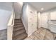 Carpeted staircase with white railing leading to the upper level, located near multiple doors and hallways at 1197 Mission View Ct, Henderson, NV 89002
