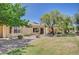 Charming backyard with grass area, desert landscaping, and covered patio for outdoor living at 1466 Fieldbrook St, Henderson, NV 89052