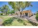 Expansive backyard offering a mix of green grass, desert landscaping, and covered patio at 1466 Fieldbrook St, Henderson, NV 89052