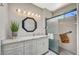 Modern bathroom featuring a granite vanity, decorative mirror, and a glass-enclosed shower at 1466 Fieldbrook St, Henderson, NV 89052