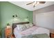 This bedroom boasts stylish sconces and a ceiling fan above a comfortable bed at 1466 Fieldbrook St, Henderson, NV 89052