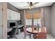 Charming dining area featuring a round wood table, stylish chairs, built-in desk, and shelving at 1466 Fieldbrook St, Henderson, NV 89052
