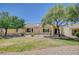 Single-story home with low maintenance desert landscaping, mature trees and covered patio at 1466 Fieldbrook St, Henderson, NV 89052