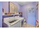 Well-appointed laundry room provides a shelf and door with floral accents at 1466 Fieldbrook St, Henderson, NV 89052