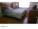 Bedroom featuring a hardwood floor, bed and nightstand with lamp at 1707 Santa Paula Dr, Las Vegas, NV 89104