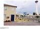 Tan two-story home with neutral tones and downtown skyline in background at 1707 Santa Paula Dr, Las Vegas, NV 89104