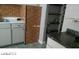 Compact kitchen featuring white cabinets, patterned backsplash and counter, complemented by shelving at 1707 Santa Paula Dr, Las Vegas, NV 89104
