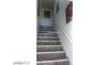 Interior staircase with white banister and contrasting stair treads, leading to the next level at 1707 Santa Paula Dr, Las Vegas, NV 89104