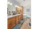 Bathroom with dual sinks, ample cabinetry, and a soaking tub, creating a luxurious and functional space at 171 Weeping Willow Ct, Pahrump, NV 89048