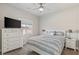 Bright bedroom with a large window, ceiling fan, bed, and modern furniture at 171 Weeping Willow Ct, Pahrump, NV 89048