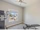 Neutral-toned bedroom with gray carpet, natural light, and exercise equipment at 171 Weeping Willow Ct, Pahrump, NV 89048