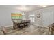Elegant dining room with a large table, chandelier, and stylish wood-look flooring at 171 Weeping Willow Ct, Pahrump, NV 89048