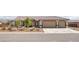 Charming single-story home with a well-manicured front yard and an attached garage at 171 Weeping Willow Ct, Pahrump, NV 89048