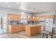 Bright kitchen features granite countertops, wood cabinets, stainless appliances, and a central island at 171 Weeping Willow Ct, Pahrump, NV 89048