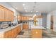 Spacious kitchen featuring wooden cabinets, granite countertops, stainless steel appliances, and wood-look tile floors at 171 Weeping Willow Ct, Pahrump, NV 89048