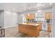 Spacious kitchen featuring granite countertops, wood cabinets, a center island, and stainless-steel appliances at 171 Weeping Willow Ct, Pahrump, NV 89048