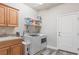 Functional laundry room with modern washer and dryer, and lots of counter space at 171 Weeping Willow Ct, Pahrump, NV 89048