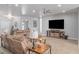 Cozy living room with plush seating, a ceiling fan, and a large television for entertainment at 171 Weeping Willow Ct, Pahrump, NV 89048