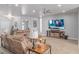 Comfortable living room featuring cozy seating, a ceiling fan, and a large television at 171 Weeping Willow Ct, Pahrump, NV 89048