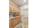 Walk-in pantry features wooden cabinets, granite countertops, and wood-look tile floors at 171 Weeping Willow Ct, Pahrump, NV 89048