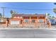 This exterior view of an orange two-story home with a well-manicured front yard at 1818 Waldman Ave, Las Vegas, NV 89102