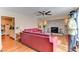 Open living room with stone fireplace, ceiling fan and hardwood floors at 1818 Waldman Ave, Las Vegas, NV 89102