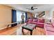 Inviting living room features hardwood floors, ceiling fan and large windows at 1818 Waldman Ave, Las Vegas, NV 89102