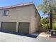 Two-story home with attached garages featuring tile roof and low maintenance landscaping at 1843 Mimosa Ct, Henderson, NV 89014