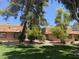 Charming condo featuring a red tile roof, complemented by mature trees and a lush green lawn at 1843 Mimosa Ct, Henderson, NV 89014