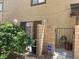 Charming townhome exterior featuring private entry with security gate, green landscaping and decorative accents at 1843 Mimosa Ct, Henderson, NV 89014