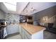 Open concept kitchen with eat-in island, bar stool seating, grey cabinets and modern lighting at 1843 Mimosa Ct, Henderson, NV 89014