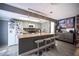 Modern kitchen with eat-in island, stainless steel appliances, and sleek grey cabinetry at 1843 Mimosa Ct, Henderson, NV 89014